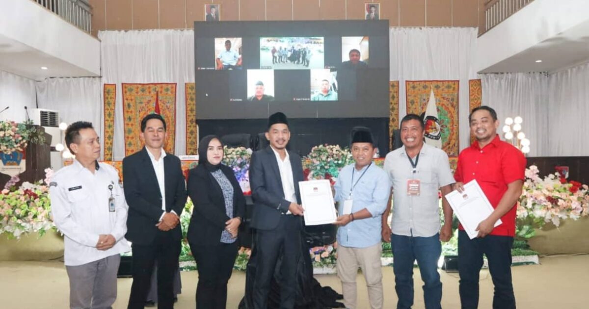 Penyerahan berita acara salinan SK penetapan pasangan calon bupati dan wakil bupati terpilih oleh Ketua KPU Boltim Rusmin Mamonto kepada Ketua Tim Oppo-Argo Hendra Damopolii
