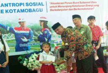 Bupati Boltim Oskar Manoppo menyerahkan beasiswa dari PGE Kotamobagu kepada siswa di Mooat